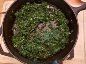 cooking spinach in butter in skillet